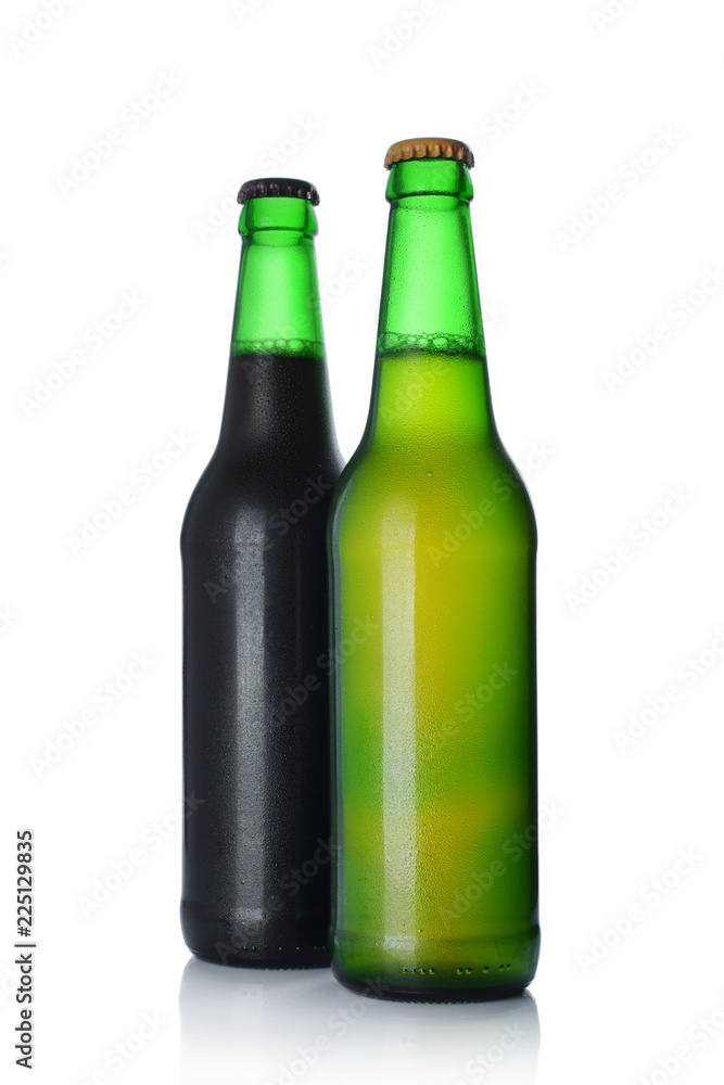 Two bottles of cold dark and light beer with drops Two bottles of cold dark and light beer with drops