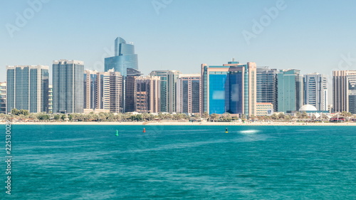 View of high skyscrapers on a corniche in Abu Dhabi stretching alongside the business center timelapse. © neiezhmakov