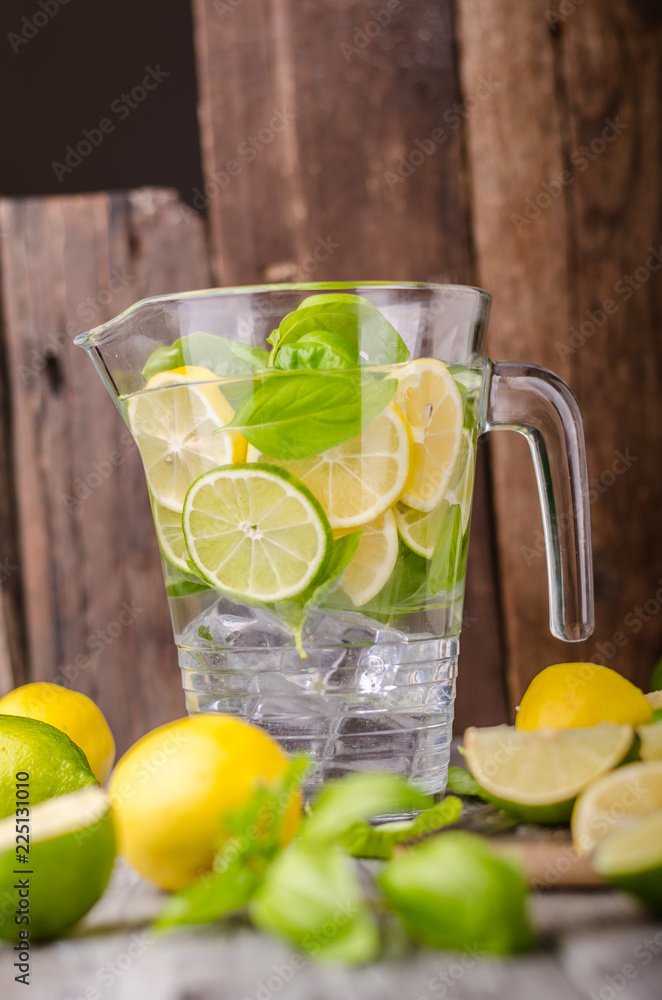 Lime lemons limonade, fresh herbs and ice in
