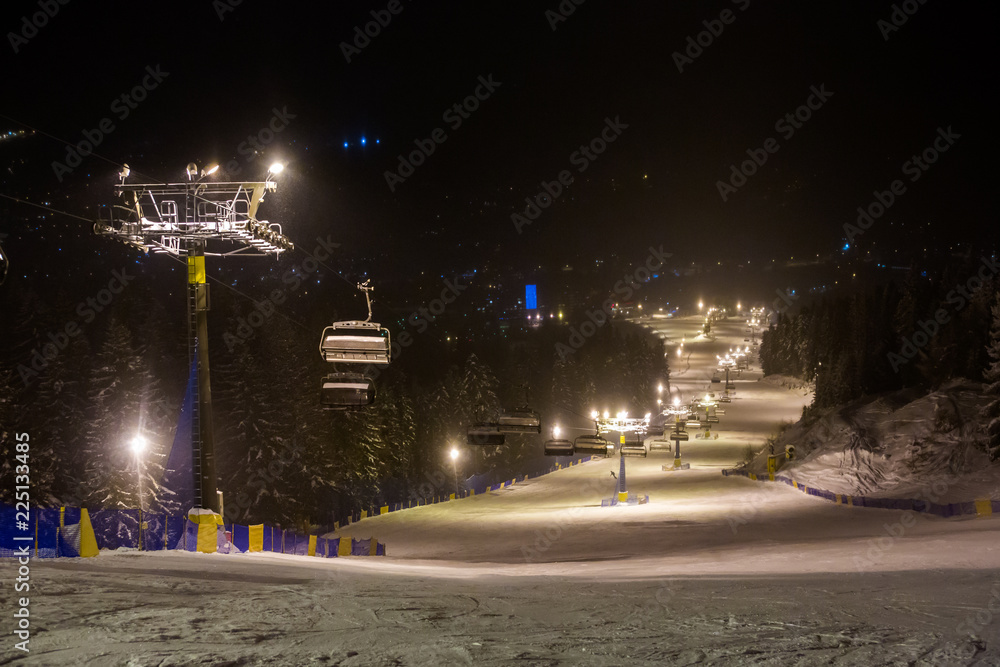 evening view of the ski resort of Zakopane, a ski trail in the night illumination