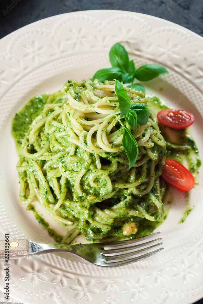Pasta spaghetti with homemade basil pesto sauce on white plate Pasta spaghetti with homemade basil pesto sauce on white plate