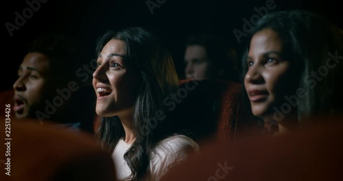 Young, diverse audience at a crowded movie theatre