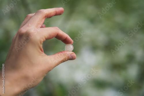 closeup male hand holding hailstones after hailstorm © GCapture