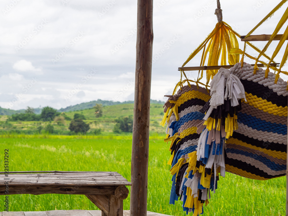 Colorful Hammock between bamboo table with rice field view. Relaxing time concept.