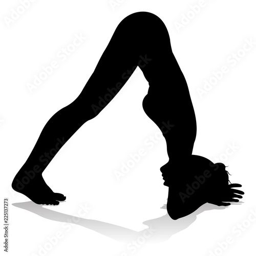 A silhouette of a woman in a yoga or pilates pose 