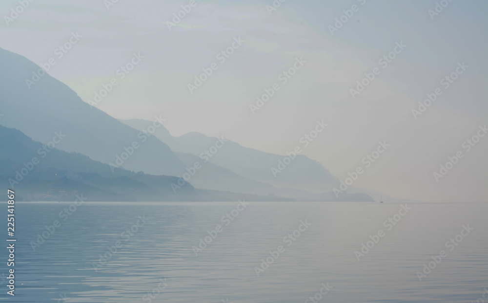Misty mountains across the ocean