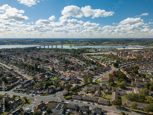 Vertical panoramic aerial view of suburban houses in Ipswich, UK. Orwell bridge and river in the background. Nice cloudy skyline.