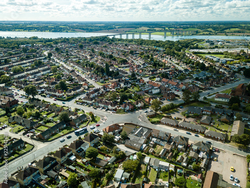 Vertical panoramic aerial view of suburban houses in Ipswich, UK. Orwell bridge and river in the background. Nice sunny day.