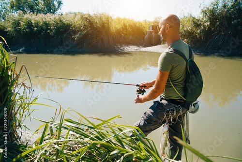 Spin fishing on a river with rod