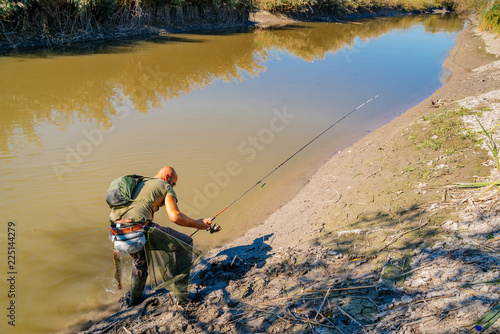 Spin fishing on a river with rod