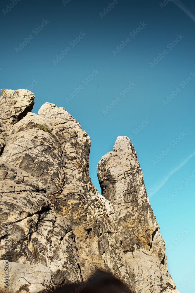 Mountain texture rocks at moody sunset landscape scenery. Sandstone rock formation Teufelsmauer (Devil's Wall) in Blankenburg, National park Harz in Germany, Harz Mountains. Mountain texture rocks at moody sunset landscape scenery. Sandstone rock formation Teufelsmauer (Devil's Wall) in Blankenburg, National park Harz in Germany, Harz Mountains.