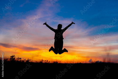 Silhouette woman jumping happily relieved. © stcom