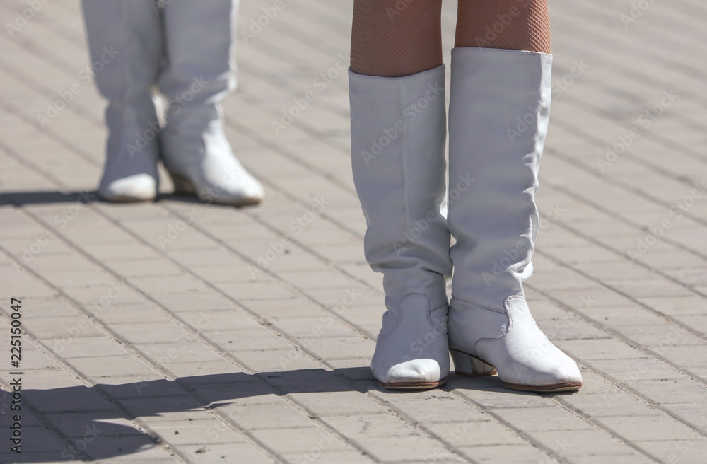 Legs of a girl in white leather boots Legs of a girl in white leather boots