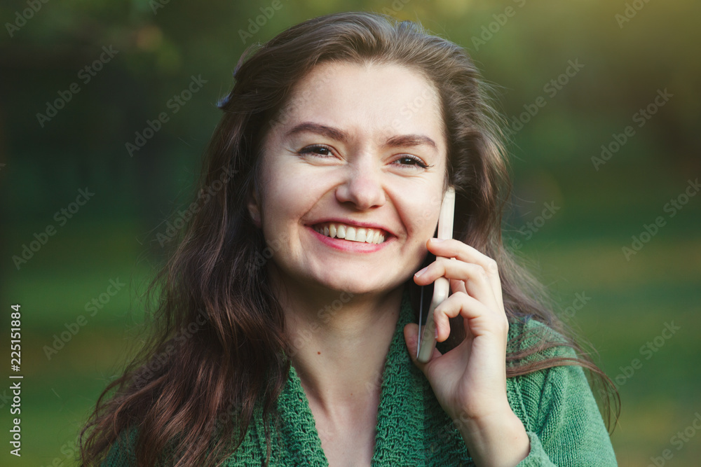 beautiful smiling young woman talking on her smartphone beautiful smiling young woman talking on her smartphone