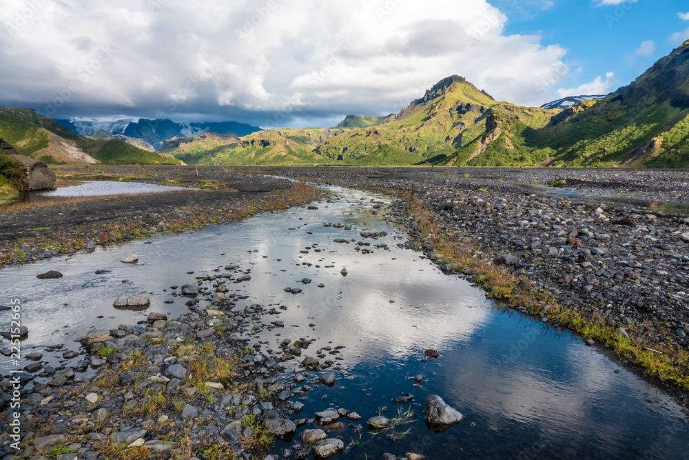 Fototapeta premium Glacial river in the dramatically beautiful and surreal landscapes of Thorsmork valley in the Highlands of Iceland at southern end of the famous Laugavegur hiking trail.