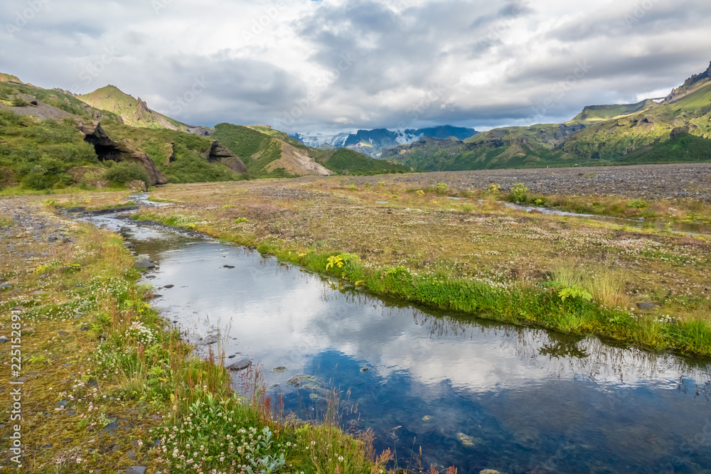 Fototapeta premium Glacial river in the dramatically beautiful and surreal landscapes of Thorsmork valley in the Highlands of Iceland at southern end of the famous Laugavegur hiking trail.