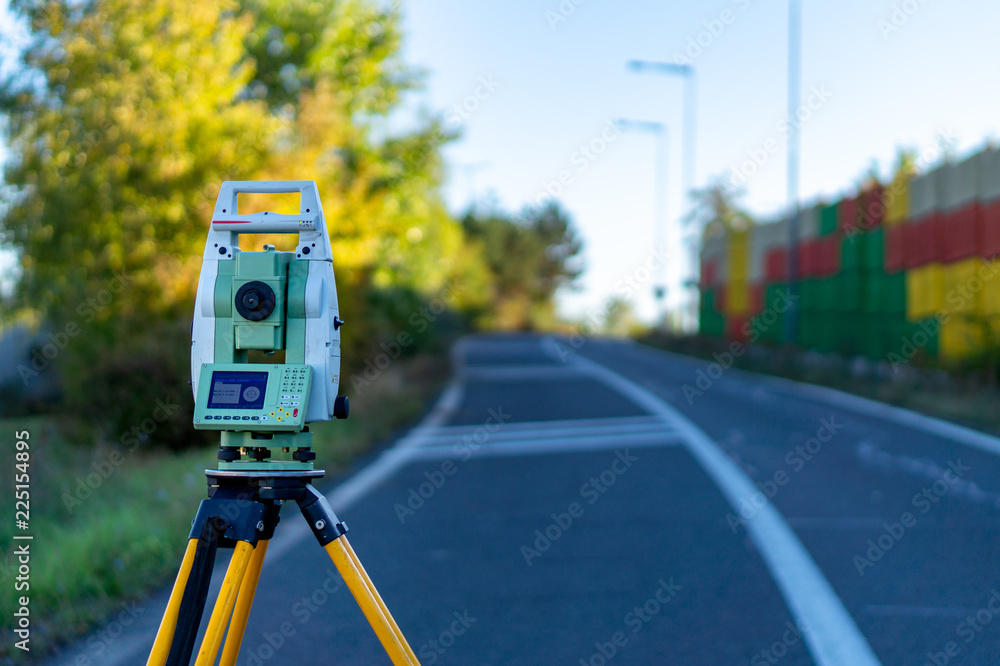 Surveyor equipment (theodolit or total positioning station) on the construction site of the motorway or road
