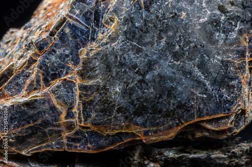Biotite (black mica) mineral on black background. photo