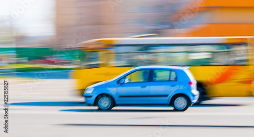 A blue car driving fast in the city of Kiev, Ukraine