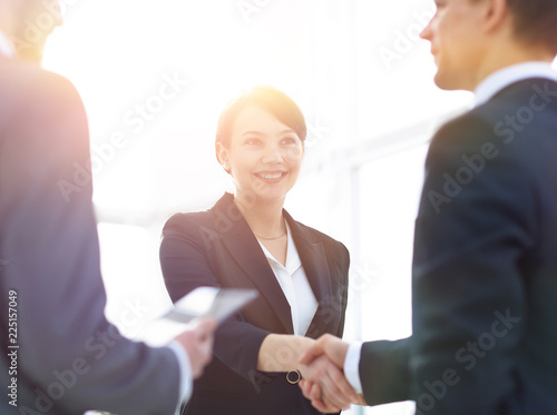 Businesswoman shaking hands with a businssman during a meeting