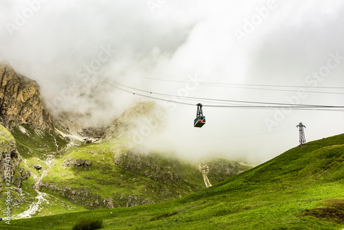 Sass Pordoi is easily one of the most visited mountains of the Dolomites. A cable-car, just visible as it enters the clouds, leads up from the road pass to its summit. The cable-car is free hanging.