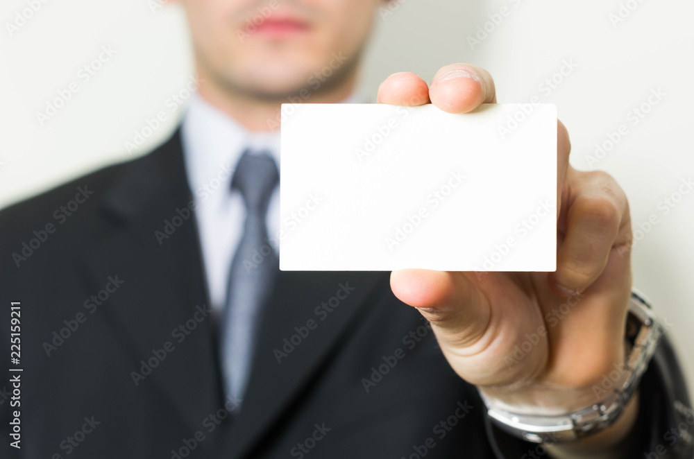 Man's hand showing business card. Close up on white background Man's hand showing business card. Close up on white background