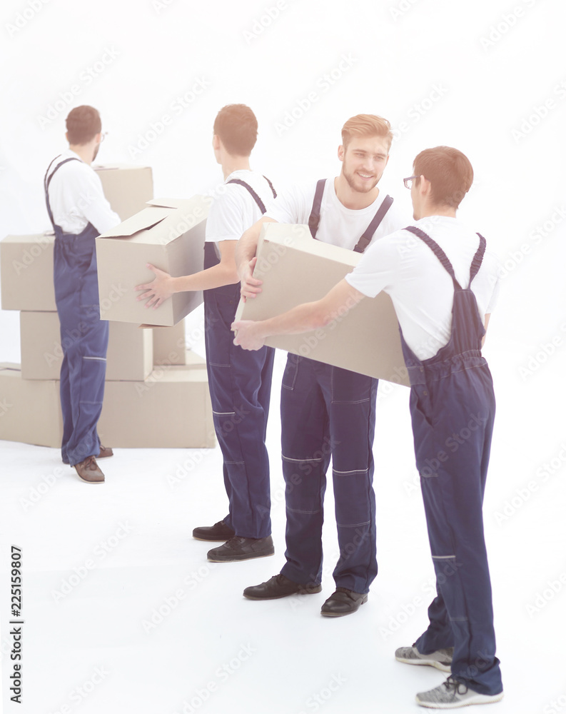 Photo workers pass each other boxes when moving flats. Photo workers pass each other boxes when moving flats.
