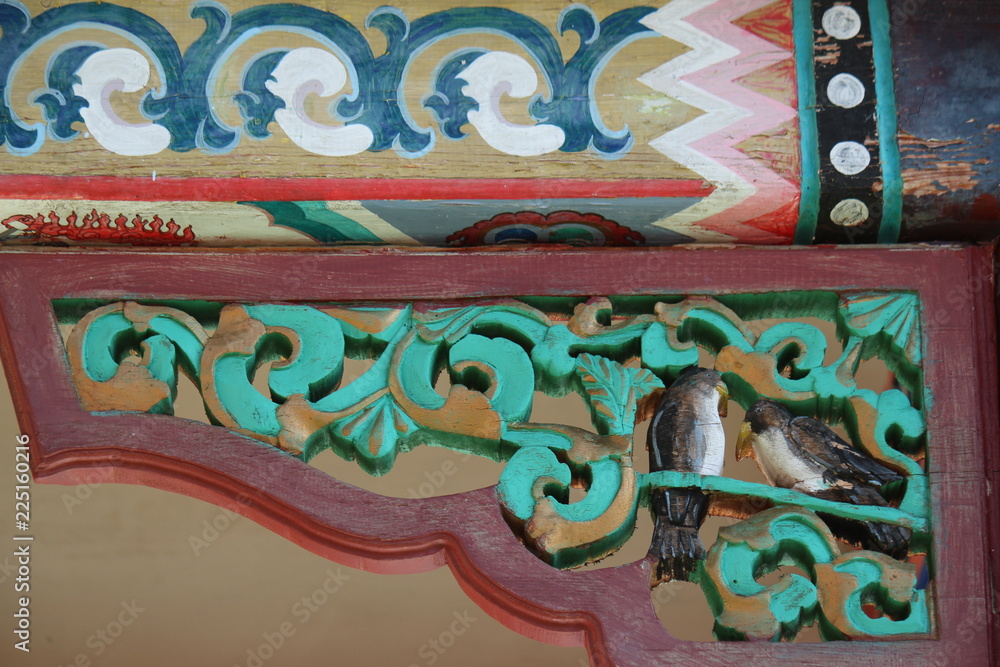 Exterior wood carving and painting, buddhist and religious decoration and art of tibetian monastery and meditation center at Terelji National Park, Mongolia, Asia