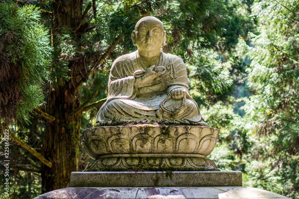 Buddhist sculpture depicting departed monk in the Okunoin cemetery in Koyasan Mount Koya, UNESCO world heritage site and a 1200 years old center of Japanese sect of of Shingon Buddhism Buddhist sculpture depicting departed monk in the Okunoin cemetery in Koyasan Mount Koya, UNESCO world heritage site and a 1200 years old center of Japanese sect of of Shingon Buddhism