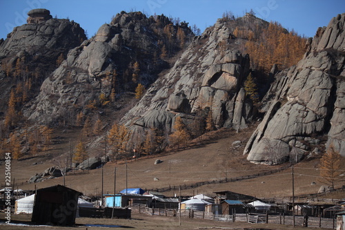 Mountain range and rock formation with ger, yurt and barn in autumn fall at Terelji National Park, Mongolia