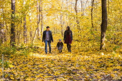 Children, nature and family concept - Portrait of happy family over autumn park background