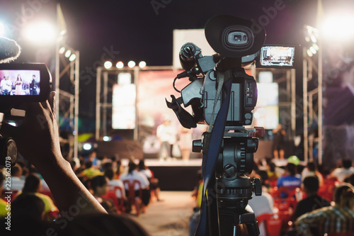 Professional digital camera recording video in music concert festival