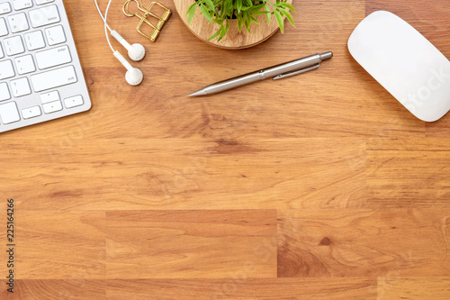 Wood office desk table with a lot of supplies on it. Top view, flat lay.