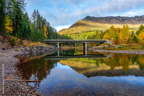 bridge over a creek surrounded by autumn colors, Glacier National Park, Montana