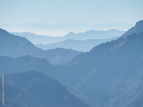 Landscape on hills and Alps mountains with humidity in the air and pollution. Panorama from Farno Mountain, Bergamo, Italy