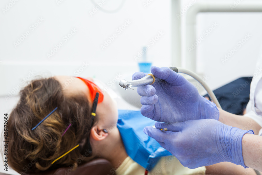 dentist preparing to treat a woman's teeth. Close-up dental high speed turbine. dentist preparing to treat a woman's teeth. Close-up dental high speed turbine.