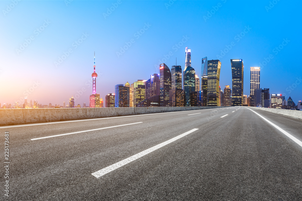 Empty asphalt road and modern city landmark building in Shanghai at night