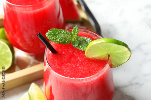 Summer watermelon drink with mint and lime on table, closeup
