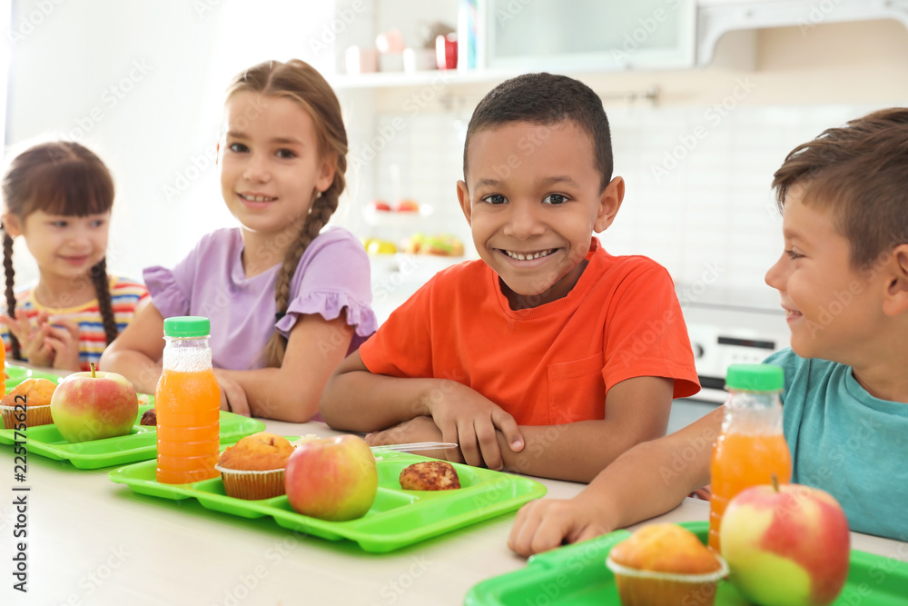 Children sitting at table and eating healthy food during break at school Children sitting at table and eating healthy food during break at school