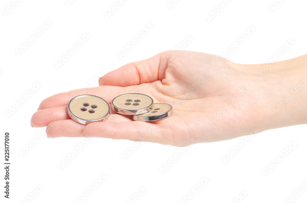 Buttons for clothes accessories in a hand on a white background isolation Buttons for clothes accessories in a hand on a white background isolation