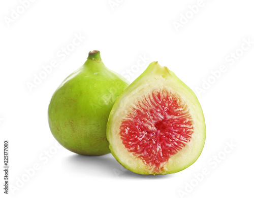 Whole and cut green figs on white background