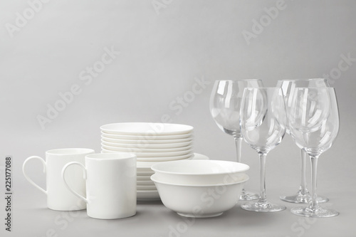 Set of clean tableware on grey background. Washing dishes