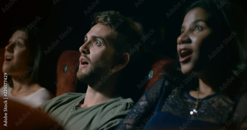 Unbelievable moment in a film causing a movie theatre audience to react with surprise, shock and awe. Slow motion Unbelievable moment in a film causing a movie theatre audience to react with surprise, shock and awe. Slow motion