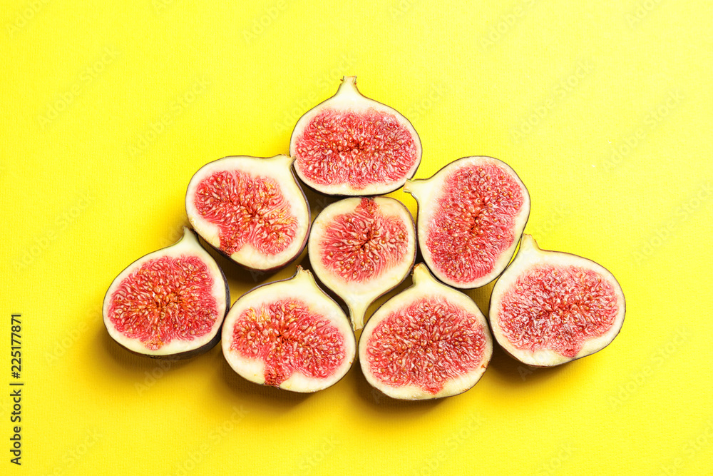 Cut ripe figs on color background, top view Cut ripe figs on color background, top view
