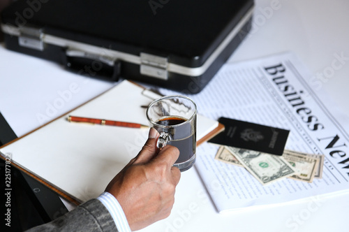 businessman holding coffee with business newpaper. photo