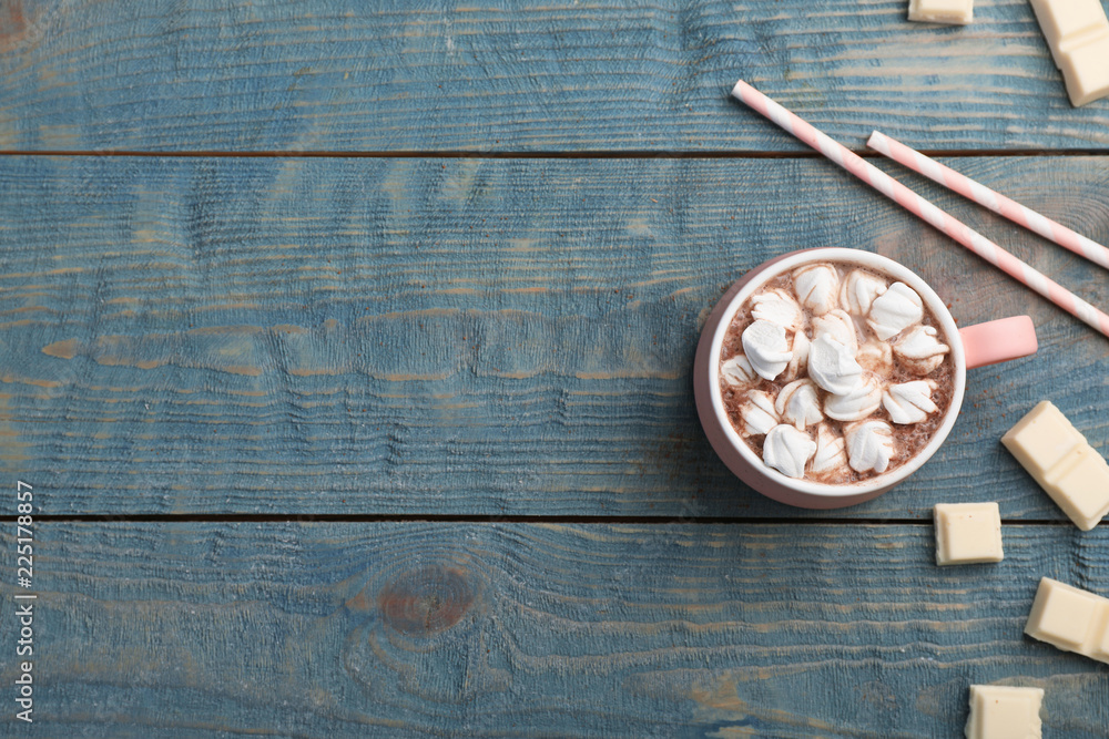 Cup of chocolate milk with marshmallows on wooden background, flat lay. Space for text Cup of chocolate milk with marshmallows on wooden background, flat lay. Space for text