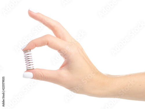 Metal spring in a hand on a white background isolation