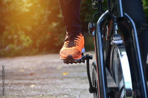 Female exercising on bicycle for exercising and healthy lifestyle concept.