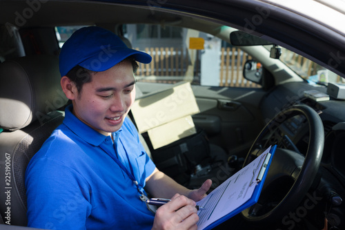 Delivery man checking order and customer address in his truck. Delivery service concept