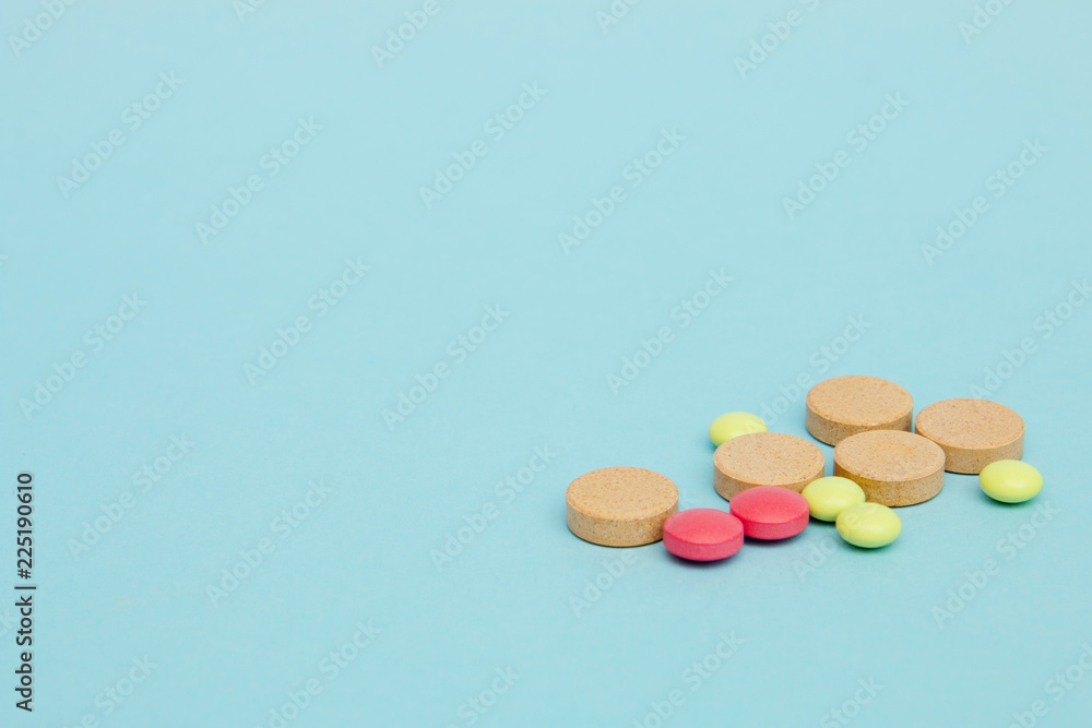 Different medicines tablets on blue background selective focus, copy space Different medicines tablets on blue background selective focus, copy space